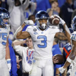 
              North Carolina's Antoine Green (3) celebrates with Spencer Rolland (75) and Josh Downs (11) after scoring during the second half of the team's NCAA college football game against Duke in Durham, N.C., Saturday, Oct. 15, 2022. (AP Photo/Ben McKeown)
            