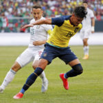 
              FILE - Ecuador defender Xavier Arreaga (14) controls the ball while defended by Mexico midfielder Jose Guardado (18) during the first half of an international friendly soccer match Sunday, June 5, 2022, in Chicago. (AP Photo/Jon Durr, File)
            
