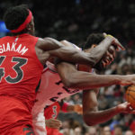 
              Philadelphia 76ers center Joel Embiid (21) is fouled by Toronto Raptors forward Pascal Siakam (43) during the second half of an NBA basketball game, Wednesday, Oct. 26, 2022 in Toronto. (Frank Gunn/The Canadian Press via AP)
            