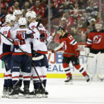 
              Washington Capitals defenseman Nick Jensen (3) celebrates with teammates after scoring a goal past New Jersey Devils goaltender Mackenzie Blackwood, back right, in the second period of an NHL hockey game Monday, Oct. 24, 2022, in Newark, N.J. (AP Photo/Adam Hunger)
            