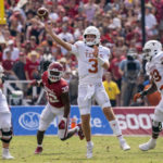 
              Texas quarterback Quinn Ewers (3) throws a pass in front of Oklahoma defensive lineman R Mason Thomas (32) during the first half of an NCAA college football game at the Cotton Bowl, Saturday, Oct. 8, 2022, in Dallas. (AP Photo/Jeffrey McWhorter)
            
