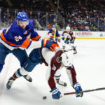 
              New York Islanders defenseman Scott Mayfield (24) and Colorado Avalanche's Alex Newhook (18) battle for the puck in the first period of an NHL hockey game, Saturday, Oct. 29, 2022, in Elmont, N.Y. (AP Photo/Eduardo Munoz Alvarez)
            