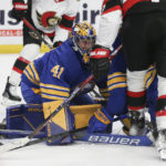 
              Buffalo Sabres goaltender Craig Anderson (41) blocks a shot during the second period of the team's NHL hockey game against the Ottawa Senators on Thursday, Oct. 13, 2022, in Buffalo, N.Y. (AP Photo/Joshua Bessex)
            