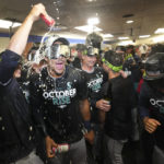 
              Seattle Mariners, including Julio Rodriguez, second from left in front, celebrate in the clubhouse after defeating the Toronto Blue Jays in Game 2 of a baseball AL wild-card playoff series Saturday, Oct. 8, 2022, in Toronto. (Nathan Denette/The Canadian Press via AP)
            