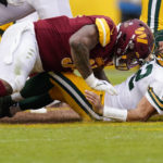 
              Washington Commanders defensive tackle Daron Payne, left, hits Green Bay Packers quarterback Aaron Rodgers (12) during the second half of an NFL football game Sunday, Oct. 23, 2022, in Landover, Md. Payne was given a roughing the passer penalty. (AP Photo/Patrick Semansky)
            