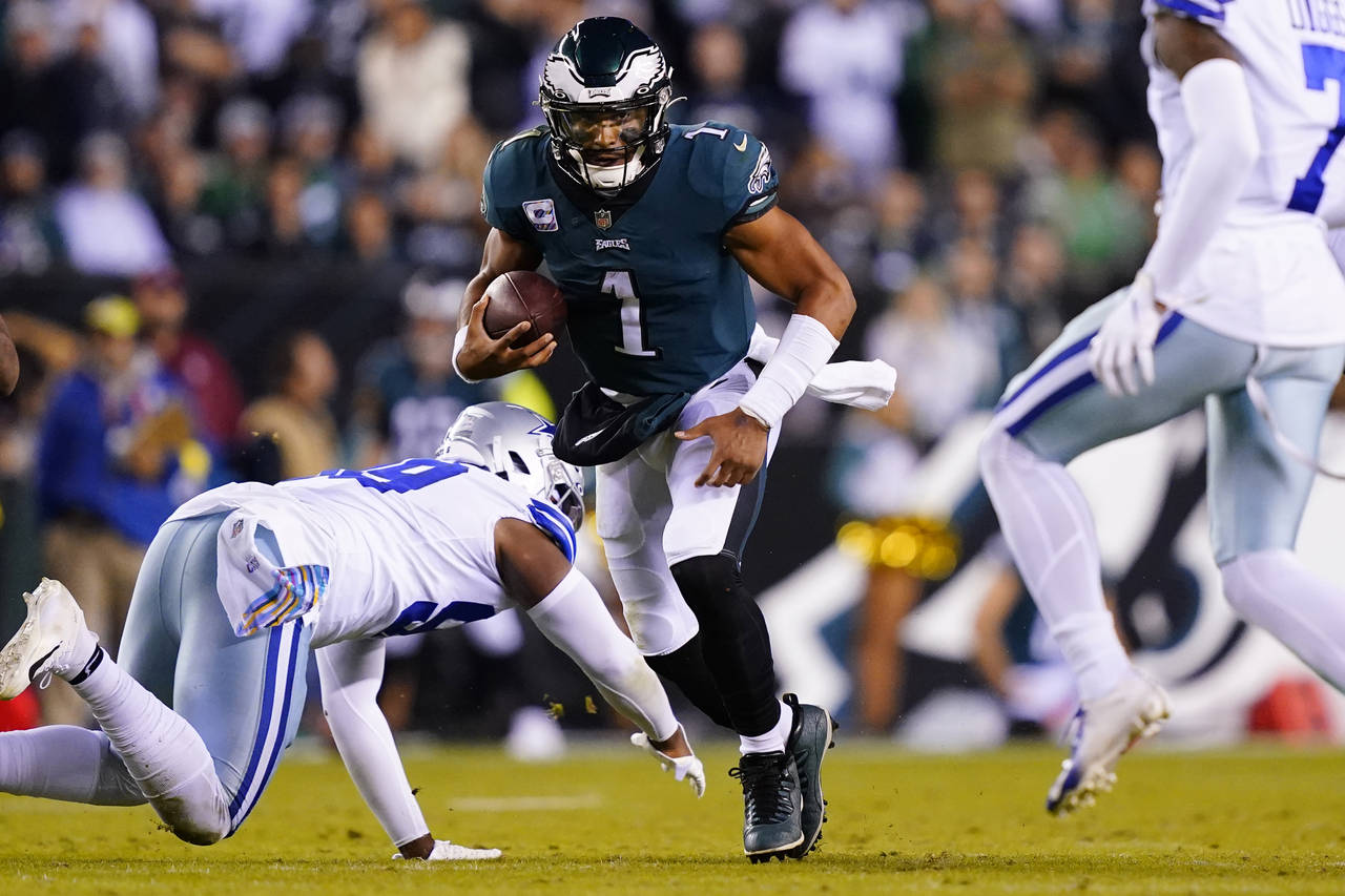 Philadelphia Eagles' Jalen Hurts runs with the ball during the second half of an NFL football game ...