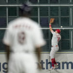 
              Philadelphia Phillies left fielder Kyle Schwarber can't get a glove on a double by Houston Astros' Alex Bregman during the 10th inning in Game 1 of baseball's World Series between the Houston Astros and the Philadelphia Phillies on Friday, Oct. 28, 2022, in Houston. (AP Photo/Eric Gay)
            