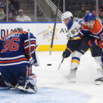 
              St. Louis Blues' Jake Neighbours (63) is stopped by Edmonton Oilers goalie Jack Campbell (36) as Oilers' Brett Kulak (27) defends during the third period of an NHL game in Edmonton, Alberta, Saturday, Oct. 22, 2022. (Jason Franson/The Canadian Press via AP)
            