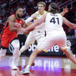 
              Houston Rockets guard Eric Gordon, left, drives around Utah Jazz forwards Lauri Markkanen, middle, and Kelly Olynyk (41) during the first half of an NBA basketball game, Monday, Oct. 24, 2022, in Houston. (AP Photo/Michael Wyke)
            