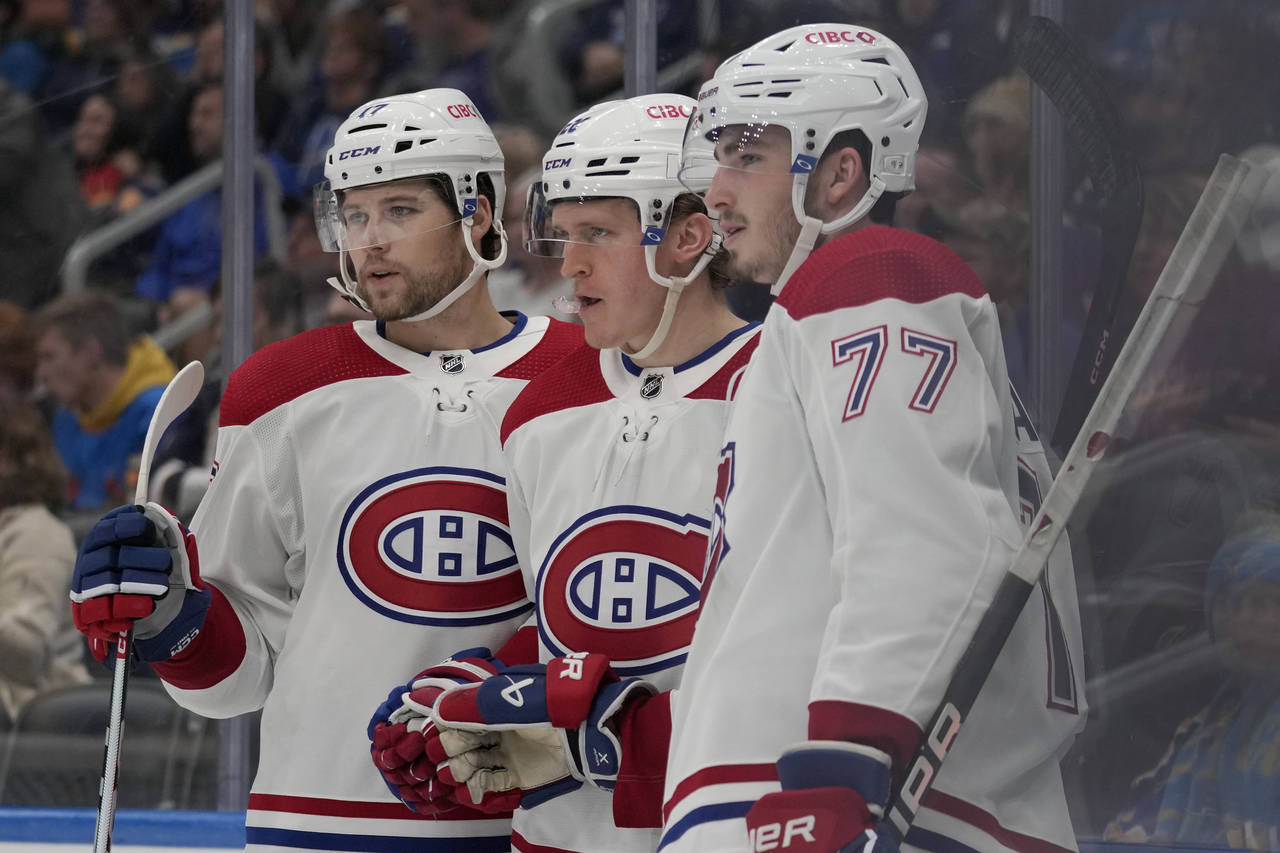 Montreal Canadiens' Christian Dvorak, center, is congratulated by teammates Josh Anderson, left, an...