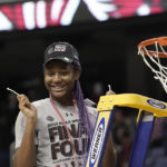 
              FILE - South Carolina forward Aliyah Boston (4) reacts after cutting the net following a college basketball game against Creighton in the Elite 8 round of the NCAA tournament in Greensboro, N.C., Sunday, March 27, 2022. Boston is a unanimous choice to the women's Associated Press preseason All-America team, Tuesday, Oct. 25, 2022. (AP Photo/Gerry Broome, File)
            