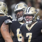 
              New Orleans Saints' Taysom Hill, right, celebrates his 60 yard rushing touchdown with Erik McCoy, left, and J.P. Holtz during an NFL football game against the Seattle Seahawks in New Orleans, Sunday, Oct. 9, 2022. (AP Photo/Gerald Herbert)
            