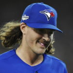 
              Toronto Blue Jays starting pitcher Kevin Gausman smiles after being taken out during the sixth inning of Game 2 of a baseball AL wild-card playoff series against the Seattle Mariners, Saturday, Oct. 8, 2022, in Toronto. (Nathan Denette/The Canadian Press via AP)
            