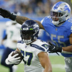 
              Detroit Lions linebacker Derrick Barnes (55) reaches in on Seattle Seahawks tight end Noah Fant (87) during the second half of an NFL football game, Sunday, Oct. 2, 2022, in Detroit. (AP Photo/Duane Burleson)
            