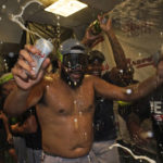 
              Atlanta Braves relief pitcher Kenley Jansen celebrates in the club house after Atlanta clinched their fifth consecutive NL East title by defeating the Miami Marlins 2-1, in a baseball game, Tuesday, Oct. 4, 2022, in Miami. (AP Photo/Wilfredo Lee)
            