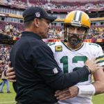 
              Washington Commanders head coach Ron Rivera, left, talks with Green Bay Packers quarterback Aaron Rodgers after an NFL football game Sunday, Oct. 23, 2022, in Landover, Md. (AP Photo/Susan Walsh)
            