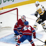 
              Pittsburgh Penguins center Evgeni Malkin (71) scores past Montreal Canadiens goaltender Sam Montembeault (35) as Canadiens defenseman Jordan Harris (54) and Penguins left wing Jason Zucker, right, look on during second-period NHL hockey game action in Montreal, Monday, Oct. 17, 2022. (Paul Chiasson/The Canadian Press via AP)
            