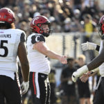 
              Cincinnati placekicker Ryan Coe, second from left, is congratulated by teammates after booting a 33-yard field goal during the first half of an NCAA college football game against Central Florida, Saturday, Oct. 29, 2022, in Orlando, Fla. (AP Photo/Phelan M. Ebenhack)
            