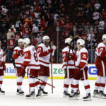 
              Detroit Red Wings goaltender Alex Nedeljkovic (39) is congratulated by teammates after the third period of an NHL hockey game against the New Jersey Devils Saturday, Oct. 15, 2022, in Newark, N.J. The Red Wings won 5-2. (AP Photo/Adam Hunger)
            