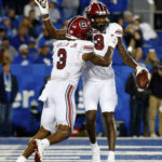 
              South Carolina wide receiver Jalen Brooks (13) waves to the Kentucky crowd while celebrating with wide receiver Antwane Wells Jr. (3) after scoring a touchdown during the second half of an NCAA college football game in Lexington, Ky., Saturday, Oct. 8, 2022. (AP Photo/Michael Clubb)
            