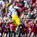 
              Michigan defensive back Mike Sainristil (0) breaks up a pass intended for Indiana wide receiver Cam Camper (6) during the second half of an NCAA college football game, Saturday, Oct. 8, 2022, in Bloomington, Ind. (AP Photo/Doug McSchooler)
            