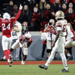 
              North Carolina State's Devan Boykin (12) intercepts a pass intended for Florida State's Mycah Pittman, as North Carolina State's Derrek Pitts Jr. (24) celebrates during the second half of an NCAA college football game in Raleigh, N.C., Saturday, Oct. 8, 2022. (AP Photo/Karl B DeBlaker)
            