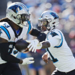 
              Carolina Panthers quarterback PJ Walker (11) hands off to Carolina Panthers wide receiver Derek Wright (83) during the second half of an NFL football game Sunday, Oct. 23, 2022, in Charlotte, N.C. The play led to a touchdown. (AP Photo/Rusty Jones)
            