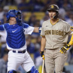 
              San Diego Padres' Ha-Seong Kim, right, reacts after striking out as Los Angeles Dodgers catcher Will Smith throws the ball back to the pitcher during the third inning in Game 1 of a baseball NL Division Series Tuesday, Oct. 11, 2022, in Los Angeles. (AP Photo/Ashley Landis)
            