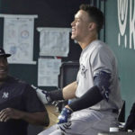 
              New York Yankees' Aaron Judge shares a laugh in the dugout in the first baseball game of a doubleheader against the Texas Rangers in Arlington, Texas, Tuesday, Oct. 4, 2022. (AP Photo/LM Otero)
            