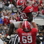 
              Georgia running back Daijun Edwards (30) celebrates his touchdown run against Florida with offensive lineman Tate Ratledge (69) during the first half of an NCAA college football game Saturday, Oct. 29, 2022, in Jacksonville, Fla. (AP Photo/John Raoux)
            