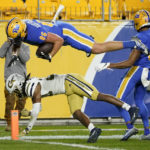 
              Pittsburgh tight end Gavin Bartholomew (86) dives over Georgia Tech defensive back LaMiles Brooks (20) into the end zone for a touchdown after catching a pass during the first half of an NCAA college football game, Saturday, Oct. 1, 2022, in Pittsburgh. (AP Photo/Keith Srakocic)
            