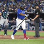 
              Toronto Blue Jays' Vladimir Guerrero Jr., center, walks back to the dugout after striking out against the Seattle Mariners during the sixth inning of Game 1 in an AL wild-card baseball playoff series in Toronto on Friday, Oct. 7, 2022. (Nathan Denette/The Canadian Press via AP)
            