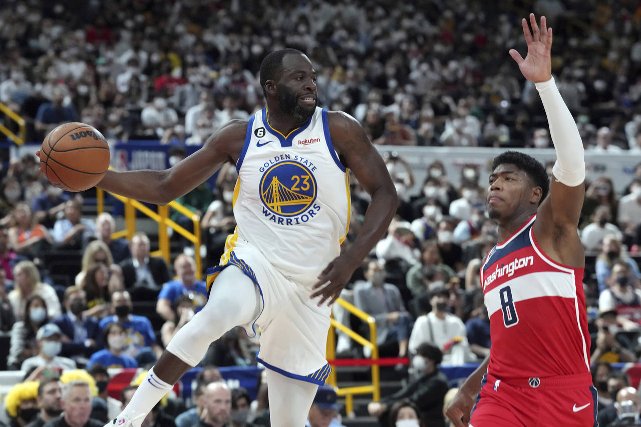 Golden State Warriors' Draymond Green (23) and Washington Wizards' Rui Hachimura (8) fight for the ...