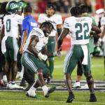 
              Tulane linebacker Nick Anderson (1) and running back Tyjae Spears (22) celebrate after Spears scored the game-winning touchdown against Houston in overtime during an NCAA college football game Friday, Sept. 30, 2022, in Houston. (Brett Coomer/Houston Chronicle via AP)
            