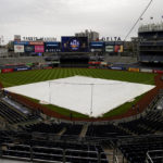 
              The rain tarp covers the field as a light rain falls on Yankee Stadium before Game 4 of an American League Championship baseball series between the New York Yankees and the Houston Astros, Sunday, Oct. 23, 2022, in New York. (AP Photo/Julia Nikhinson)
            