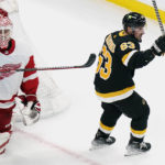 
              Boston Bruins left wing Brad Marchand, right, celebrates after a goal by Charlie Coyle, against Detroit Red Wings goaltender Ville Husso (35), during the first period of an NHL hockey game agains the Detroit Red Wings, Thursday, Oct. 27, 2022, in Boston. Marchand, who underwent offseason double-hip surgery that was supposed to keep him out until the end of November, started the game. (AP Photo/Charles Krupa)
            