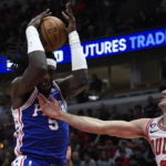 
              Philadelphia 76ers center Montrezl Harrell (5) grabs a rebound against Chicago Bulls guard Alex Caruso during the first half of an NBA basketball game Saturday, Oct. 29, 2022, in Chicago. (AP Photo/Matt Marton)
            