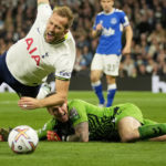 
              Everton's goalkeeper Jordan Pickford dives for a save but ends up bringing down Tottenham's Harry Kane, left, and giving away a penalty during the English Premier League soccer match between Tottenham Hotspur and Everton at the Tottenham Hotspur Stadium in London, England, Saturday, Oct. 15, 2022. (AP Photo/Kin Cheung)
            