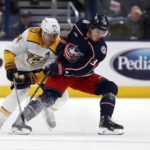 
              Columbus Blue Jackets forward Cole Sillinger, right, chases the puck in front of Nashville Predators forward Mikael Granlund during the first period of an NHL hockey game in Columbus, Ohio, Thursday, Oct. 20, 2022. (AP Photo/Paul Vernon)
            