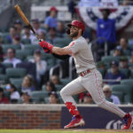 
              Philadelphia Phillies designated hitter Bryce Harper (3) hits a double during the sixth inning in Game 1 of a National League Division Series baseball game between the Atlanta Braves and the Philadelphia Phillies, Tuesday, Oct. 11, 2022, in Atlanta. (AP Photo/Brynn Anderson)
            