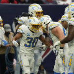 
              Los Angeles Chargers running back Austin Ekeler (30) celebrates with teammates after scoring a touchdown against the Houston Texans during the second half of an NFL football game Sunday, Oct. 2, 2022, in Houston. (AP Photo/David J. Phillip)
            