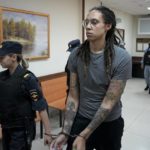 
              FILE - WNBA star and two-time Olympic gold medalist Brittney Griner is escorted from a court room after her last words, in Khimki just outside Moscow, Russia, on Aug. 4, 2022. The Moscow region's court on Monday Oct. 3, 2022 set a date for American basketball star Brittney Griner's appeal against her nine-year prison sentence for drug possession, scheduling the hearing for Oct. 25. (AP Photo/Alexander Zemlianichenko, File)
            