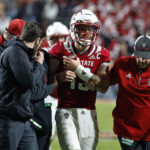 
              North Carolina State quarterback Devin Leary (13) is assisted off the field by medical staff during the second half of the team's NCAA college football game against Florida State in Raleigh, N.C., Saturday, Oct. 8, 2022. (AP Photo/Karl B DeBlaker)
            