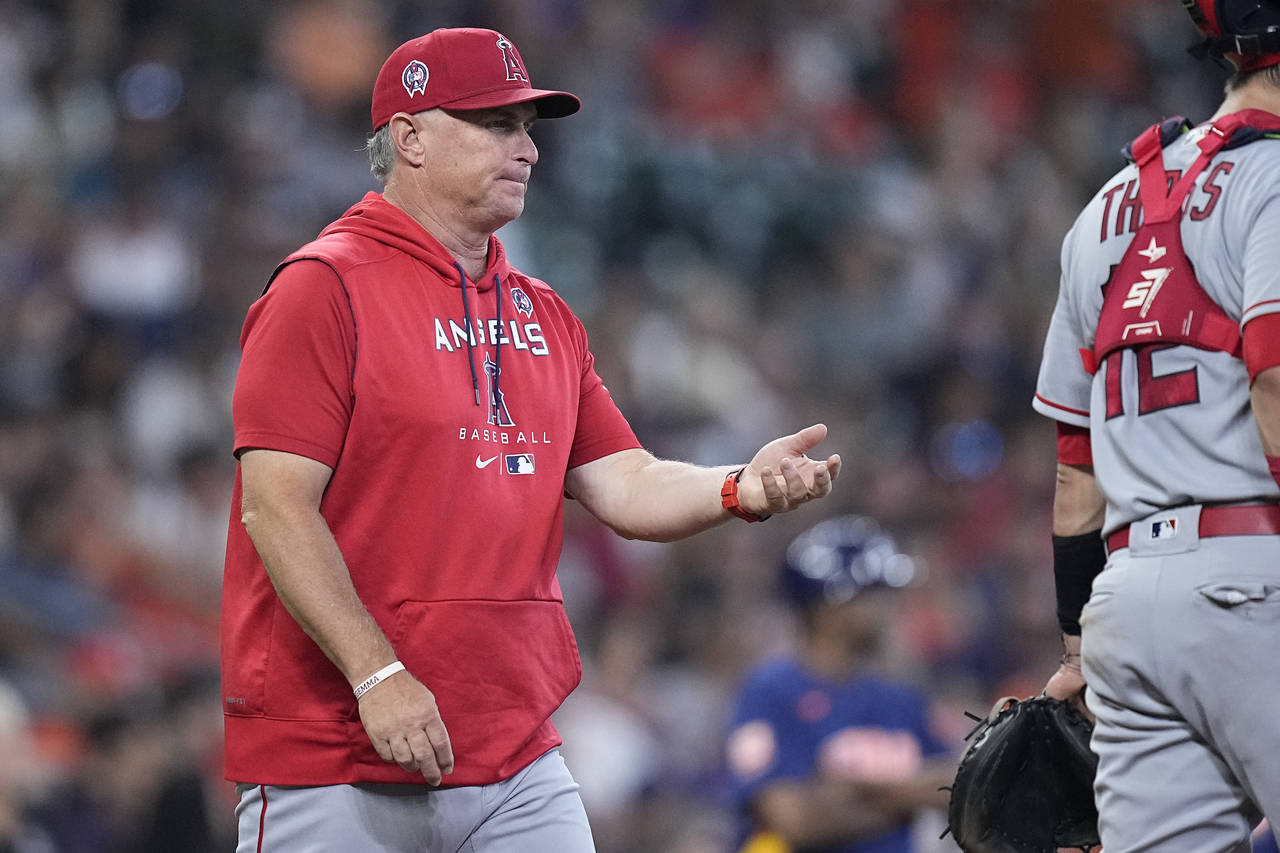 Los Angeles Angels interim manager Phil Nevin walks to the mound to pull starting pitcher Tucker Da...