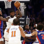 
              New York Knicks forward Julius Randle (30) looks to pass the ball in front of Detroit Pistons forward Saddiq Bey, left, during the first half of an NBA basketball game Friday, Oct. 21, 2022, in New York. (AP Photo/Adam Hunger)
            