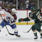 
              Colorado Avalanche defenseman Samuel Girard (49) handles the puck against Minnesota Wild left wing Kirill Kaprizov (97) during the second period of an NHL hockey game Monday, Oct. 17, 2022, in St. Paul, Minn. (AP Photo/Stacy Bengs)
            