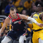 
              Washington Wizards' Kristaps Porzingis is defended by Indiana Pacers' Jalen Smith during the second half of an NBA basketball game Wednesday, Oct. 19, 2022, in Indianapolis. (AP Photo/Michael Conroy)
            