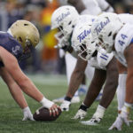 
              Navy center David Hixon, left, prepares for the snap against Tulsa defensive lineman Everitt Rogers (11), defensive lineman Joseph Anderson (44) and other teammates during the first half of an NCAA college football game, Saturday, Oct. 8, 2022, in Annapolis, Md. (AP Photo/Julio Cortez)
            