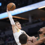 
              Utah Jazz forward Lauri Markkanen goes up for a dunk over Minnesota Timberwolves center Rudy Gobert, right, during the first half of an NBA basketball game Friday, Oct. 21, 2022, in Minneapolis. (AP Photo/Abbie Parr)
            