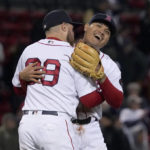 
              Boston Red Sox's Christian Arroyo hugs Yu Chang, right, after beating the Tampa Bay Rays during a baseball game at Fenway Park, Monday, Oct. 3, 2022, in Boston. (AP Photo/Mary Schwalm)
            